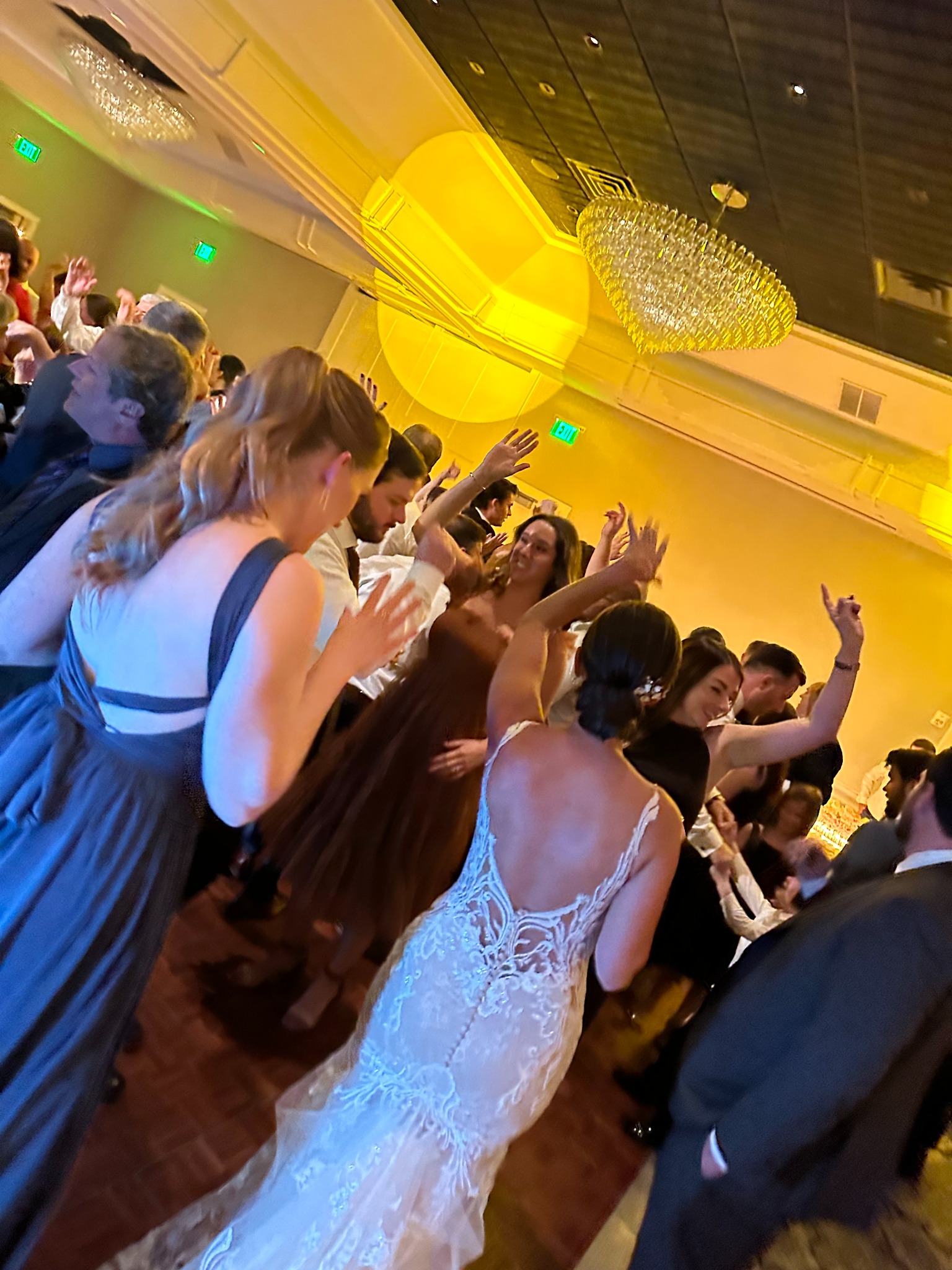 Bride dancing with guests during her wedding reception